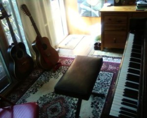 My studio where I taught piano lessons and practiced and composed, with the Chickering console.